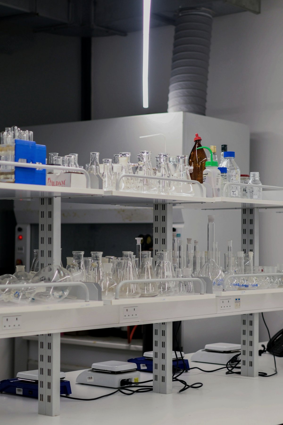 Laboratory shelves of glass flasks and beakers