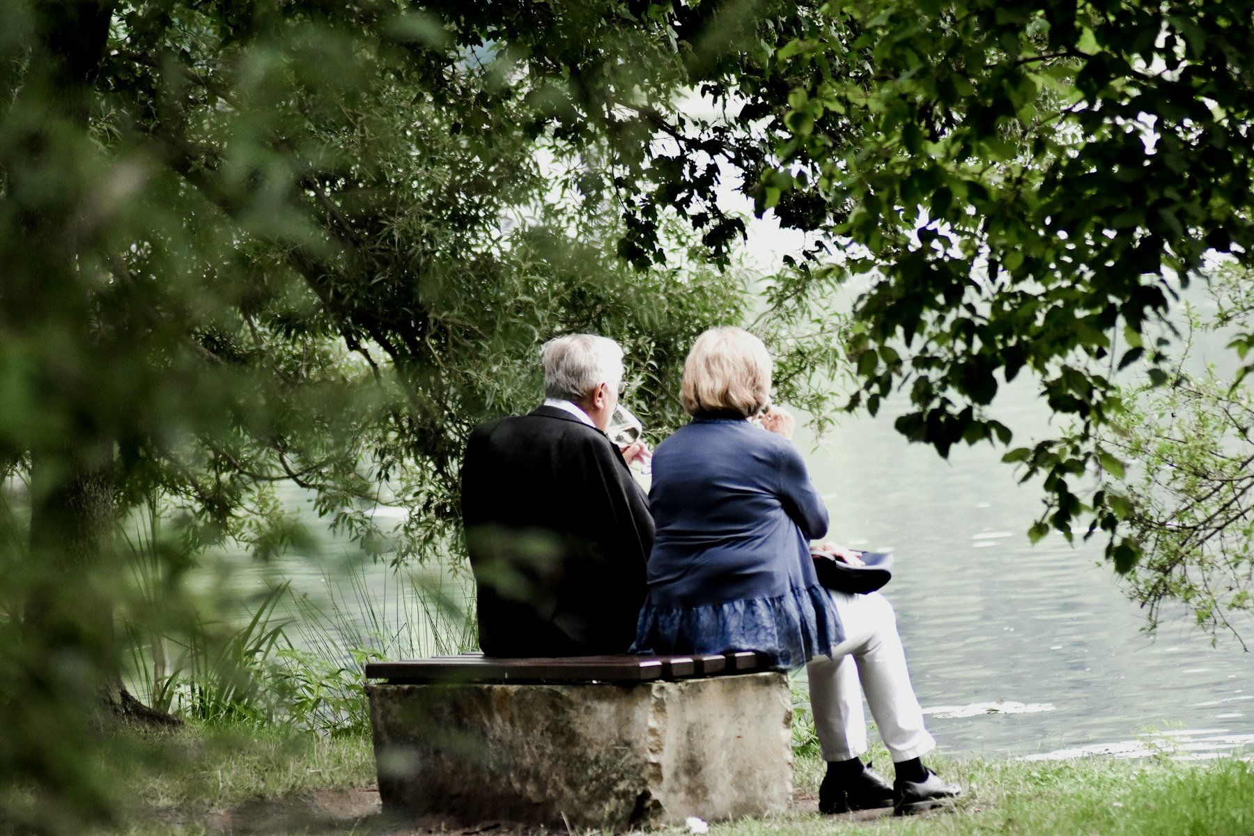 An older couple sitting together by the water